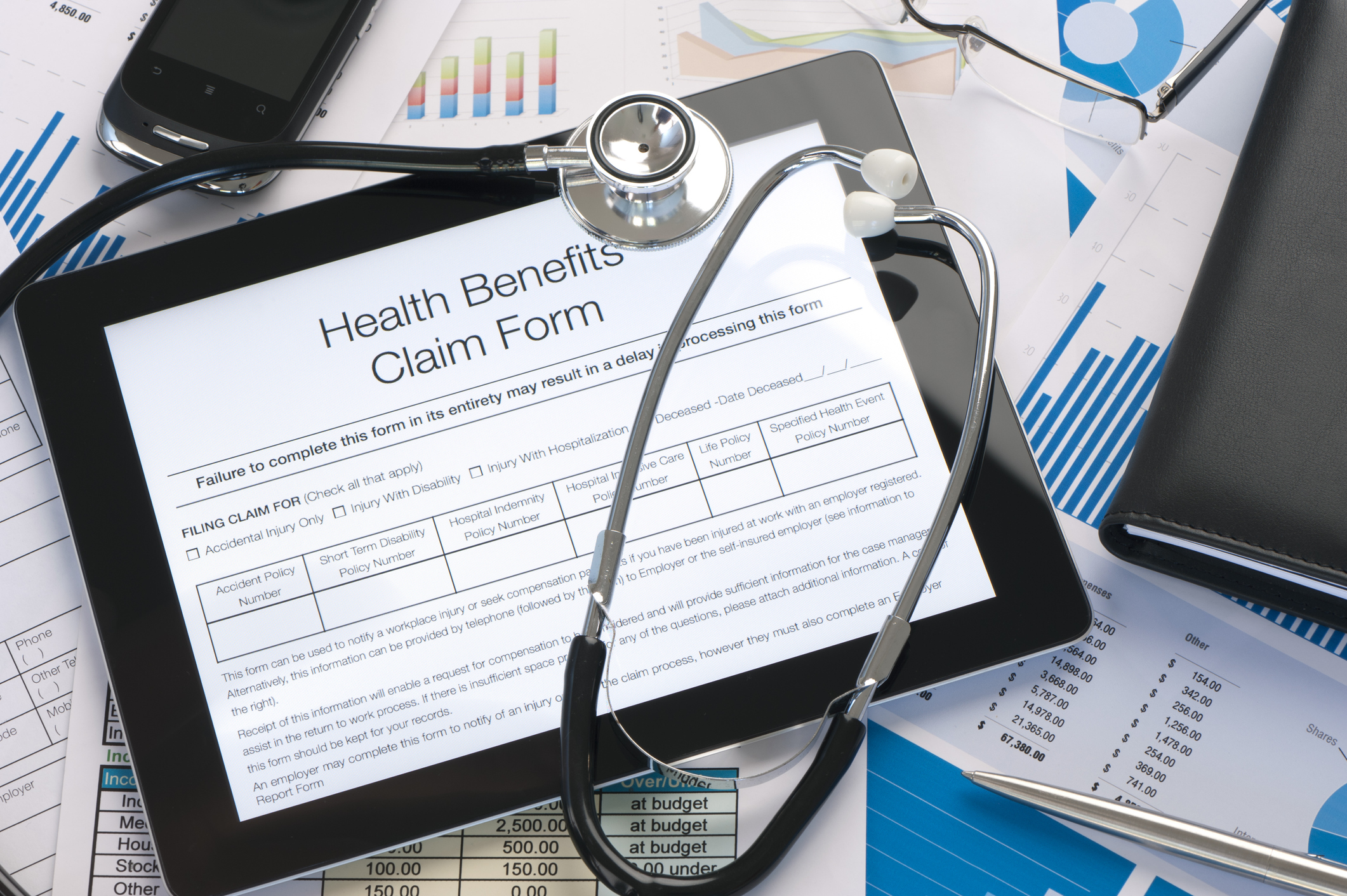 Online health benefits claim form pictured on a tablet